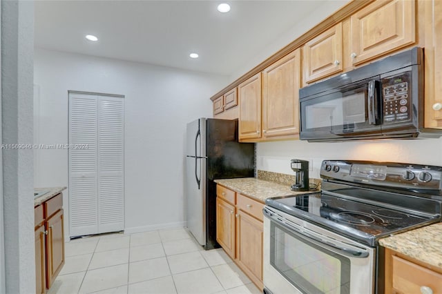 kitchen featuring electric range, light brown cabinets, light tile patterned floors, light stone countertops, and stainless steel fridge