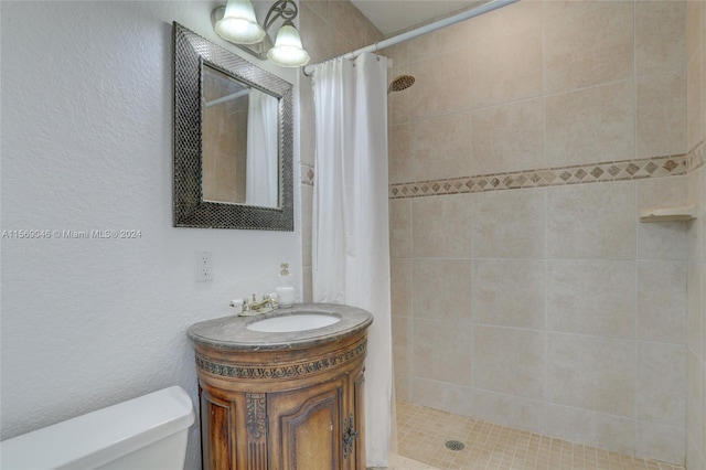 bathroom featuring curtained shower, vanity, and toilet