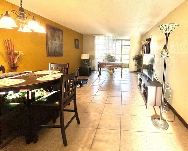 tiled dining area featuring an inviting chandelier