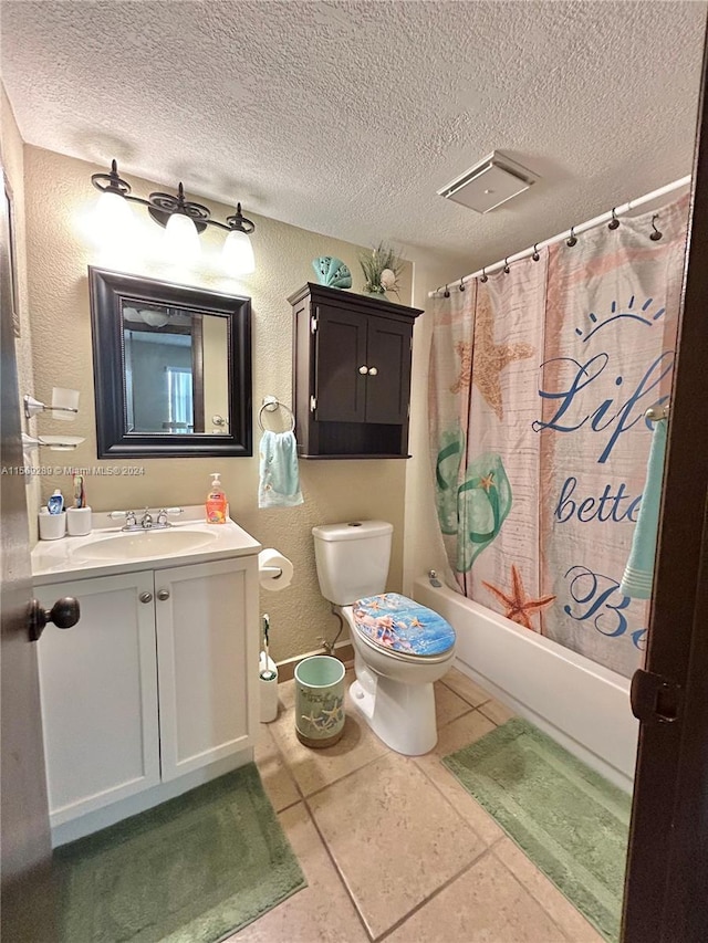 full bathroom with tile flooring, shower / bath combo with shower curtain, a textured ceiling, toilet, and vanity