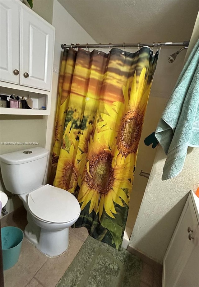 bathroom with toilet, tile floors, and vanity