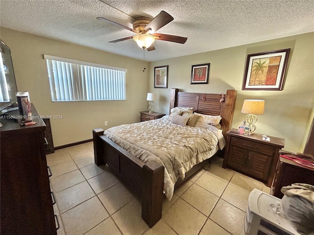 tiled bedroom featuring a textured ceiling and ceiling fan