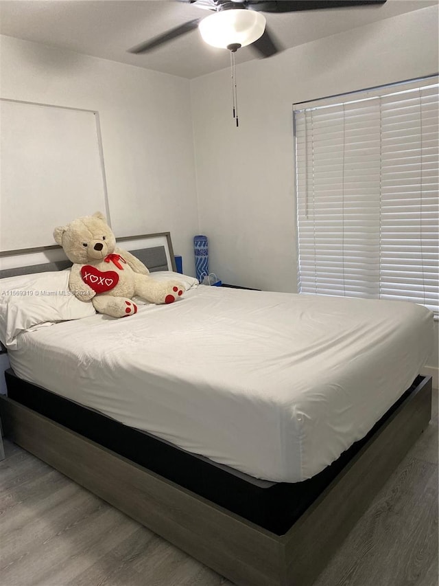 bedroom with hardwood / wood-style flooring and ceiling fan