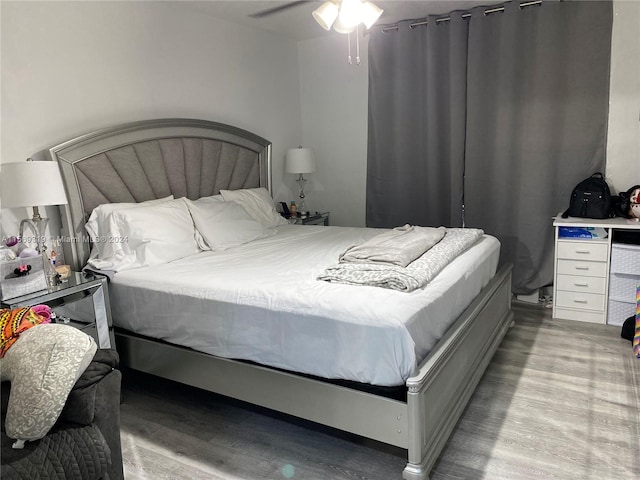 bedroom with ceiling fan and hardwood / wood-style floors