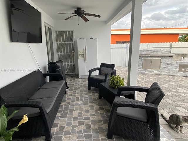 view of patio featuring ceiling fan