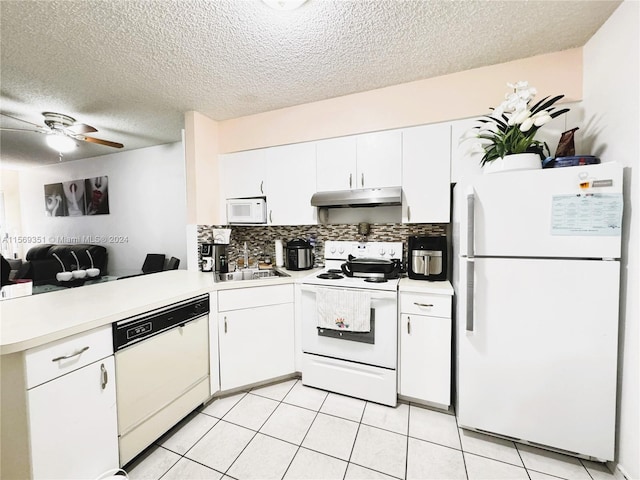 kitchen with white appliances, white cabinets, sink, ceiling fan, and kitchen peninsula