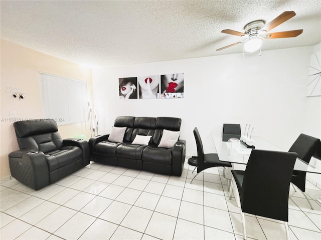 tiled living room featuring a textured ceiling and ceiling fan