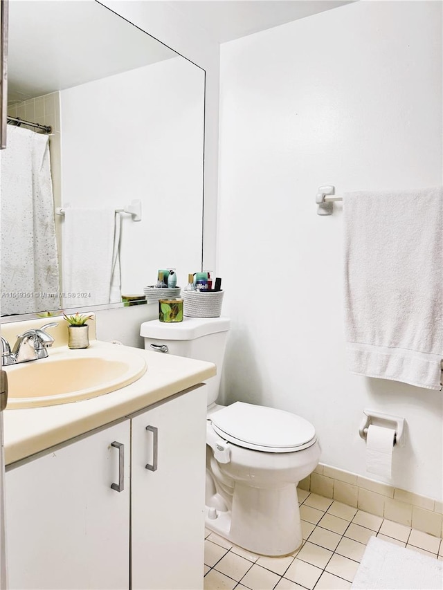 bathroom featuring tile patterned floors, vanity, and toilet