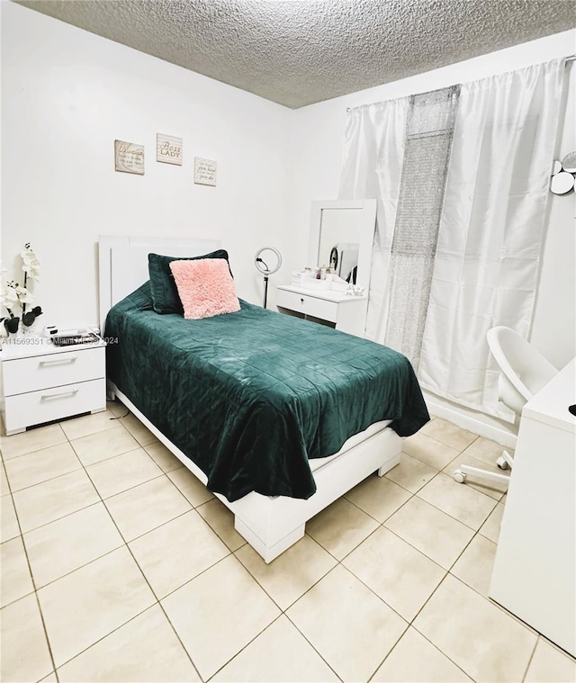 tiled bedroom with a textured ceiling