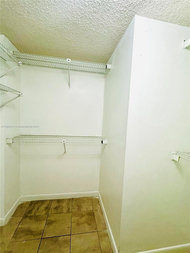 spacious closet featuring tile patterned floors