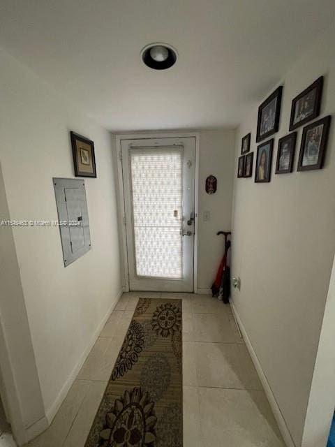 doorway to outside featuring light tile floors