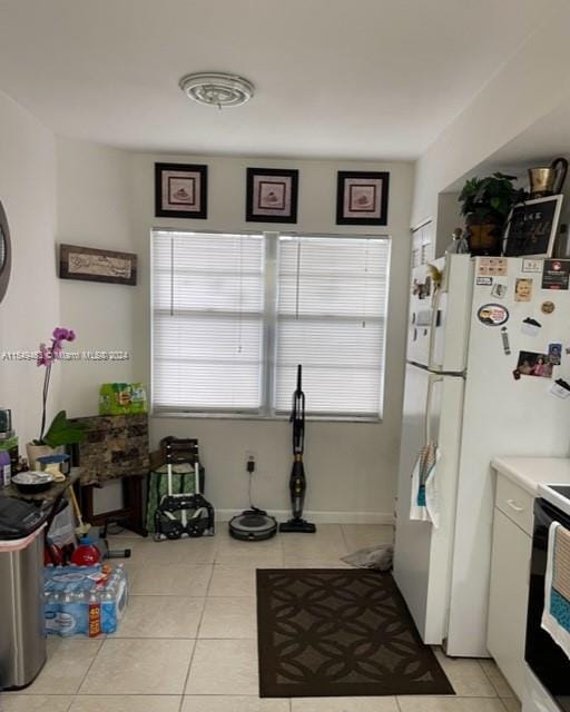 kitchen featuring light tile floors and stove