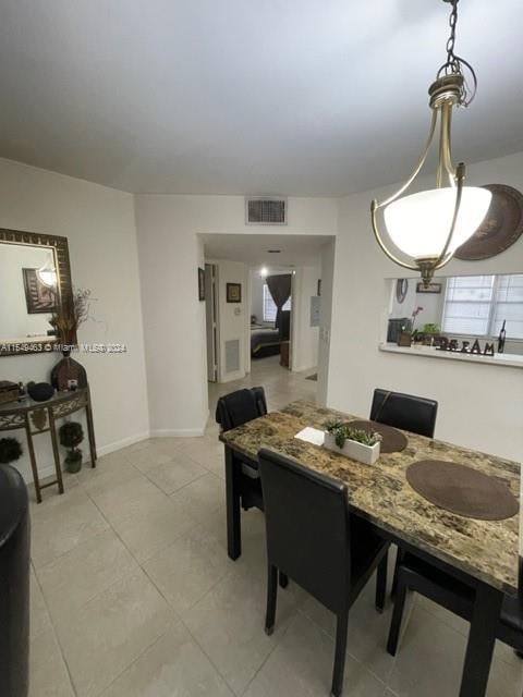 dining space with light tile floors