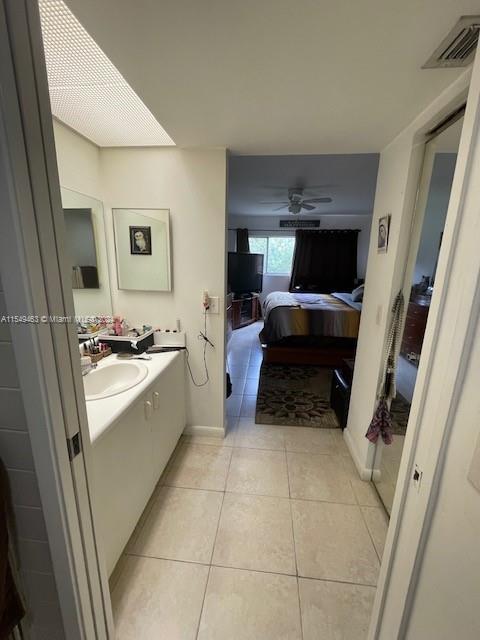 bathroom featuring tile flooring, sink, and ceiling fan