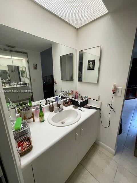 bathroom with oversized vanity and tile floors