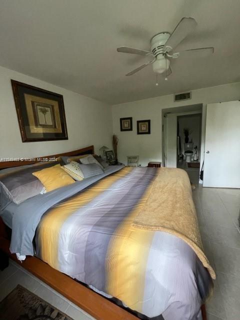 tiled bedroom with ceiling fan