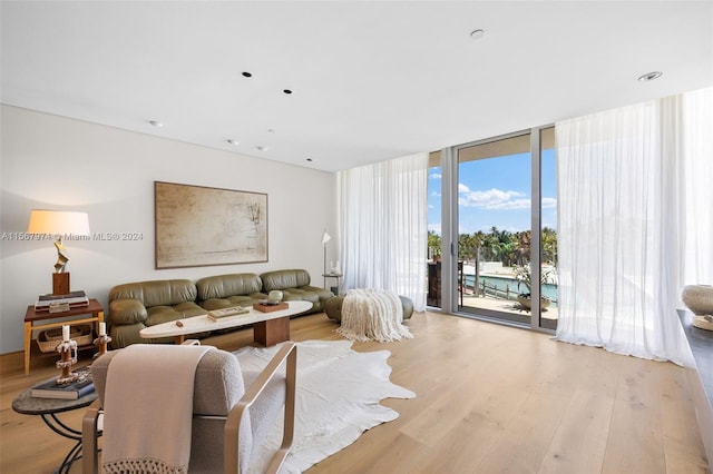 living room featuring floor to ceiling windows and light hardwood / wood-style flooring