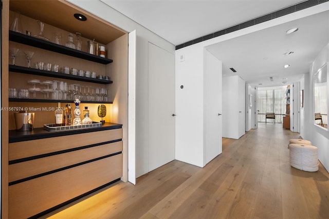 bar featuring light wood-type flooring