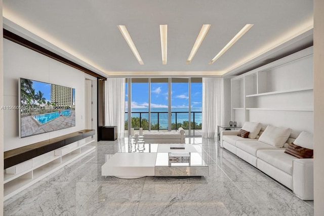 tiled living room with a wall of windows and a water view