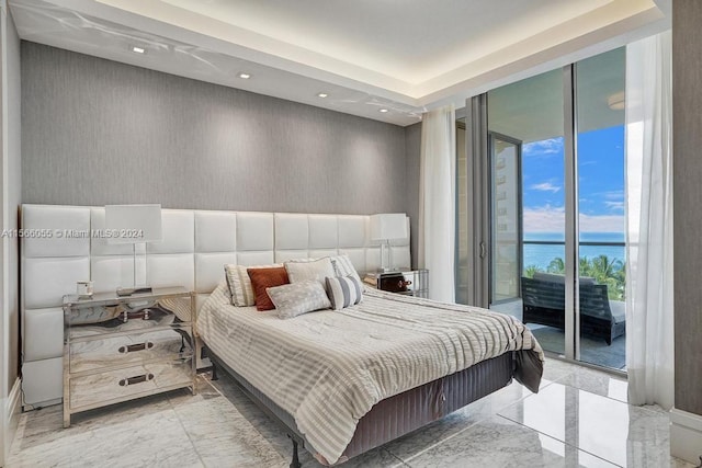 bedroom with a water view, a wall of windows, access to outside, and light tile floors