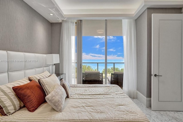 bedroom featuring a water view and light tile flooring