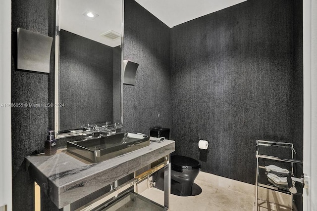 bathroom featuring vanity, toilet, and concrete floors