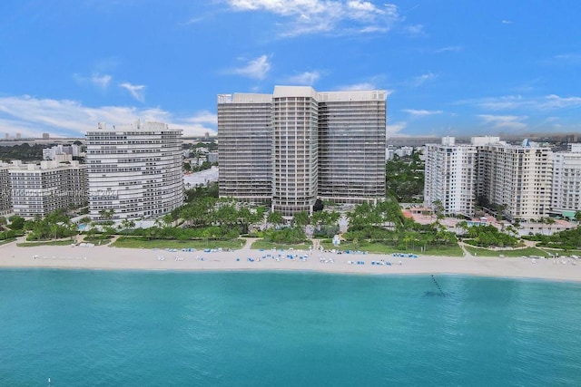 drone / aerial view with a water view and a beach view