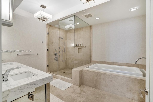 bathroom featuring tile flooring, dual sinks, and separate shower and tub