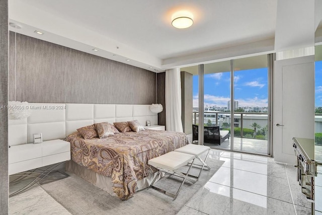 bedroom with expansive windows, a water view, light tile floors, and access to outside