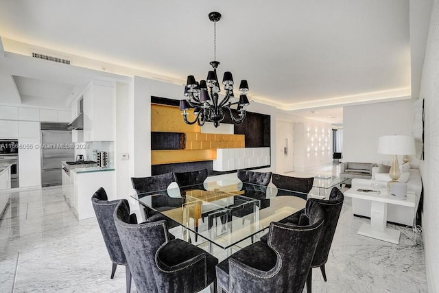 dining space with a raised ceiling, a notable chandelier, and light tile flooring