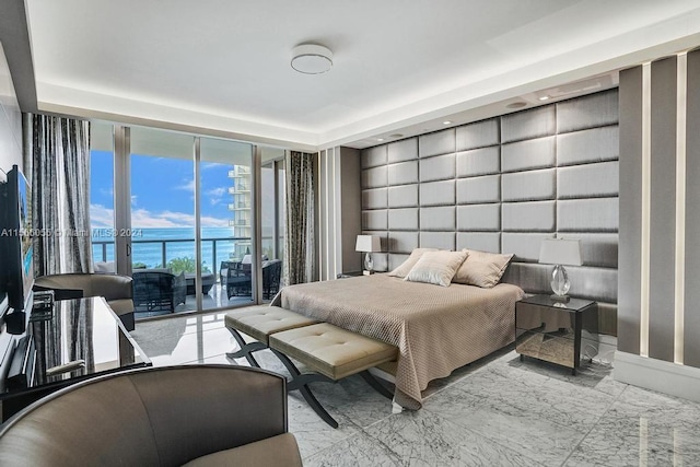 bedroom featuring a water view, access to outside, and light tile floors