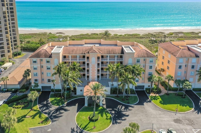 bird's eye view with a water view and a beach view