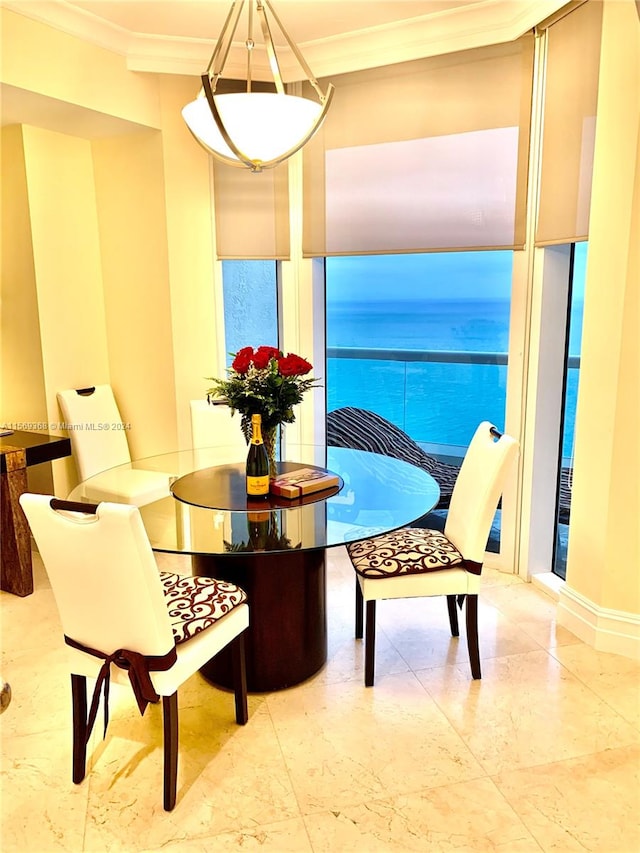 sitting room with crown molding, light tile floors, and a water view