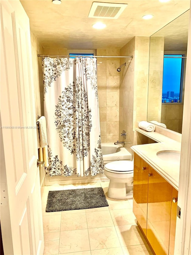 full bathroom with tile flooring, vanity, toilet, and shower / bath combo with shower curtain