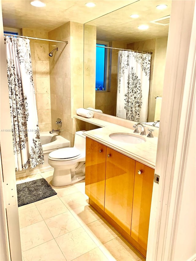 full bathroom featuring tile flooring, vanity, toilet, and shower / bath combo with shower curtain