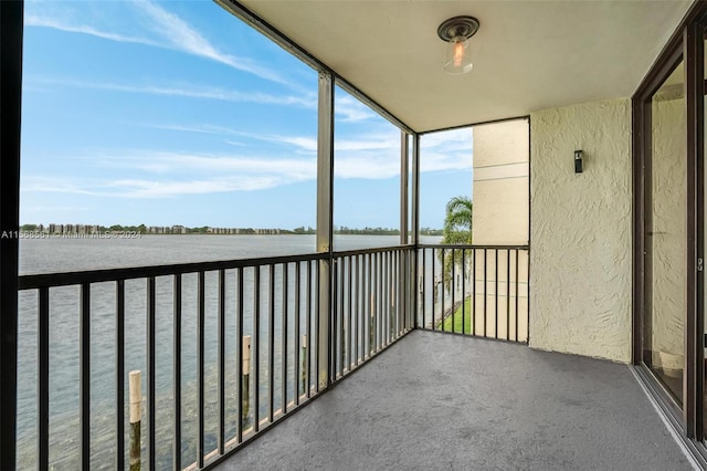 unfurnished sunroom featuring a water view