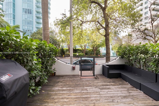 deck with an outdoor living space and grilling area