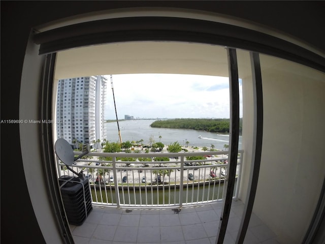 balcony with a water view and central AC