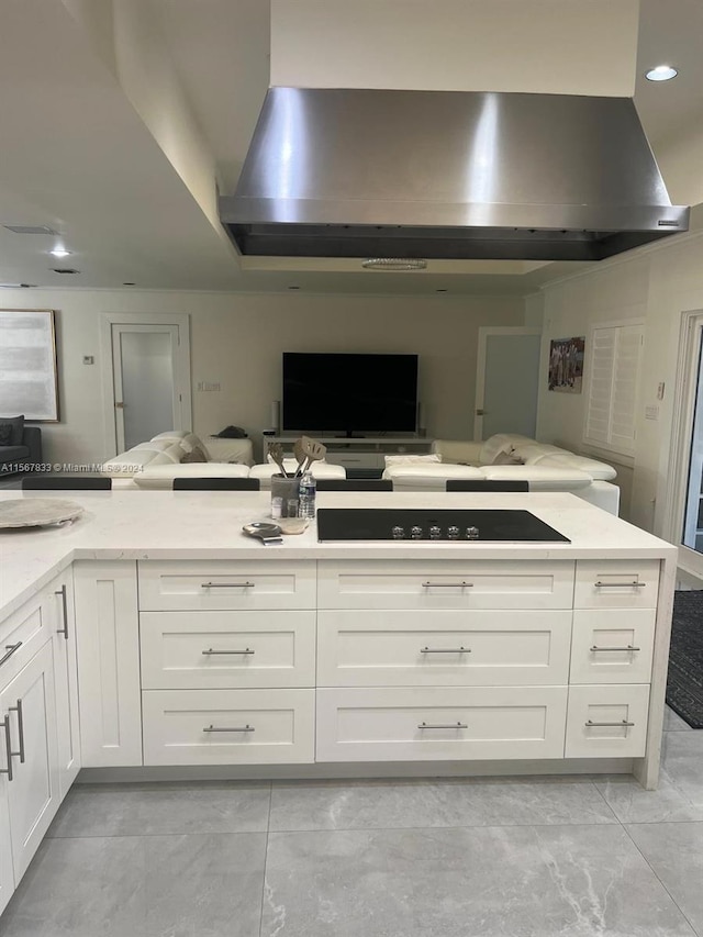 kitchen featuring gas stovetop, light stone countertops, white cabinetry, light tile floors, and exhaust hood