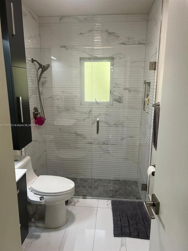 bathroom featuring toilet, a shower with shower door, tile floors, and vanity