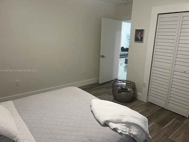 bedroom featuring dark hardwood / wood-style floors and a closet