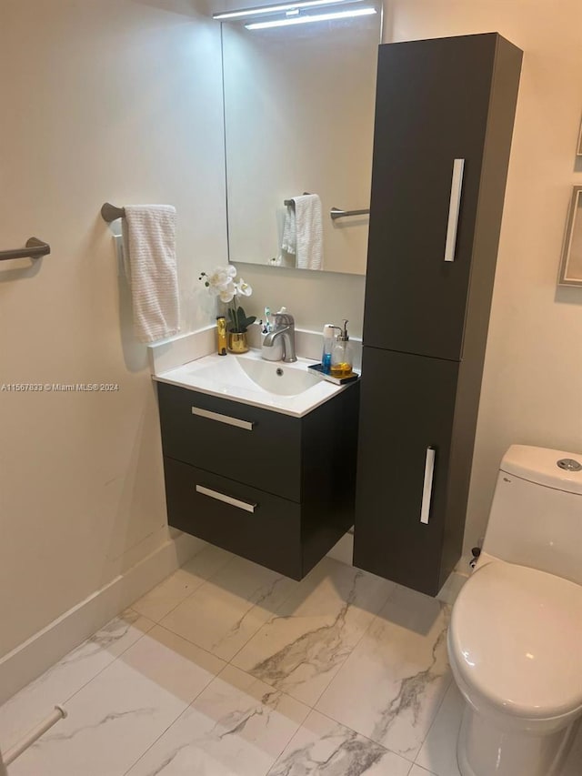 bathroom featuring vanity, toilet, and tile flooring