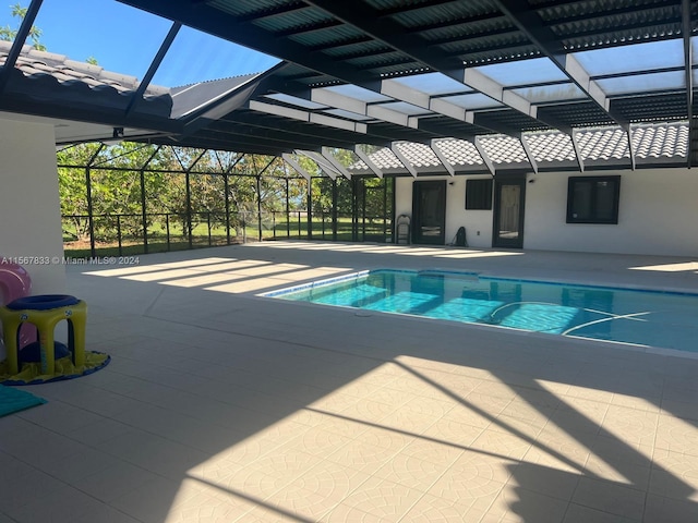 view of swimming pool with a lanai and a patio area