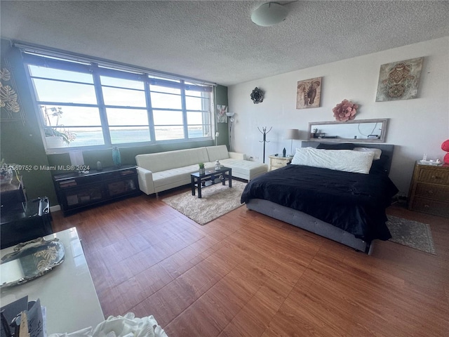 bedroom featuring dark hardwood / wood-style floors and a textured ceiling