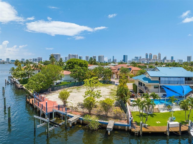 dock area with a pool, a patio, and a water view