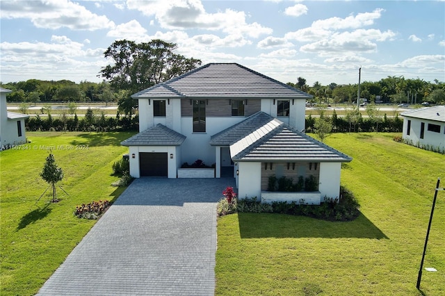 view of front of house with a garage and a front yard