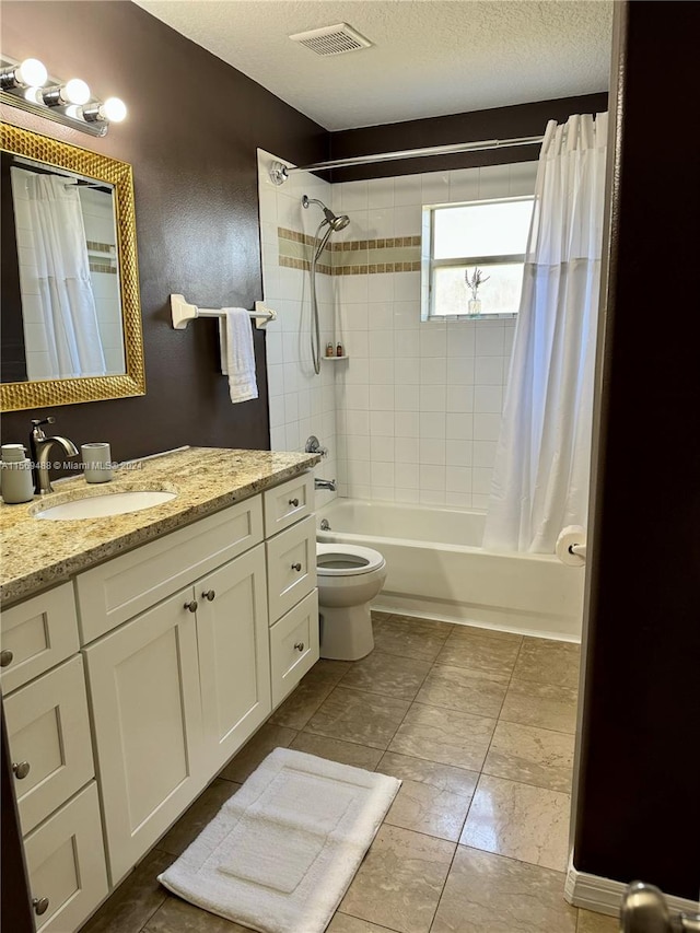 full bathroom with a textured ceiling, shower / bath combo, tile floors, toilet, and vanity