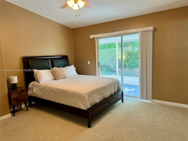 bedroom with light carpet, ceiling fan, access to exterior, and a textured ceiling