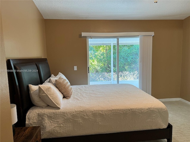 carpeted bedroom with a textured ceiling