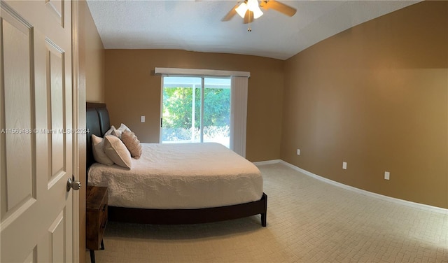 bedroom with light colored carpet, ceiling fan, and a textured ceiling